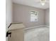 Cozy bedroom features tile floors and natural light from the window with blinds at 13635 Coronado Dr, Spring Hill, FL 34609