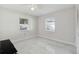 Bedroom with tile floors, ceiling fan, and two windows with blinds providing natural light at 13635 Coronado Dr, Spring Hill, FL 34609