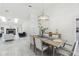 Bright dining room features chandelier, dining table and chairs, open to living room with fireplace at 13635 Coronado Dr, Spring Hill, FL 34609