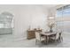 Well lit dining room features high ceiling, chandelier, modern furniture and sleek marble floors at 13635 Coronado Dr, Spring Hill, FL 34609