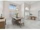 Bright dining room with a large window, high ceiling, modern chandelier, and elegant furnishings at 13635 Coronado Dr, Spring Hill, FL 34609