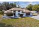 Charming one-story home with a well-manicured front lawn, driveway, and two-car garage at 13635 Coronado Dr, Spring Hill, FL 34609