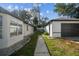 A walkway between the house and the detached garage with easy access at 13635 Coronado Dr, Spring Hill, FL 34609