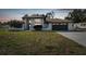 Charming home featuring a well-manicured lawn and a two-car garage, creating an inviting curb appeal at 13635 Coronado Dr, Spring Hill, FL 34609