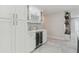 Kitchen wet bar includes a wine refrigerator, ample cabinet space, and stylish backsplash at 13635 Coronado Dr, Spring Hill, FL 34609