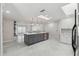 Bright, open kitchen boasts a large island, stainless steel appliances, and seamless flow to the living area at 13635 Coronado Dr, Spring Hill, FL 34609