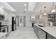 Modern kitchen with stainless steel appliances, white cabinets, gray island, and luxury finishes at 13635 Coronado Dr, Spring Hill, FL 34609