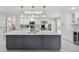 Modern kitchen with stainless steel appliances, white cabinets, gray island, and luxury finishes at 13635 Coronado Dr, Spring Hill, FL 34609