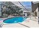 Enclosed pool featuring a waterfall feature, jacuzzi and an entertainment area at 13635 Coronado Dr, Spring Hill, FL 34609