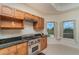 Gourmet kitchen with a stainless steel Wolf range, granite countertops and bright windows at 14 Somerset St # 5C, Clearwater, FL 33767