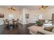 Bright living room with elegant hardwood floors, ceiling fans, dining area, and comfortable seating at 14 Somerset St # 5C, Clearwater, FL 33767