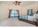 Bright main bedroom with a ceiling fan, access to a balcony overlooking the beach, and a large bed at 14 Somerset St # 5C, Clearwater, FL 33767