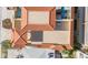 Birds-eye view of a multi-story property with a distinctive red tile roof, patios and possible pool at 146 175Th Terrace E Dr, Redington Shores, FL 33708