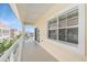 Spacious balcony featuring wrought iron railings and views of neighboring buildings and blue skies at 146 175Th Terrace E Dr, Redington Shores, FL 33708