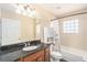 Bathroom featuring a shower-tub combo, vanity with granite countertops, and tiled floors at 146 175Th Terrace E Dr, Redington Shores, FL 33708
