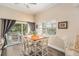 Dining room with a bright window, sliding glass door, and wooden floor at 146 175Th Terrace E Dr, Redington Shores, FL 33708