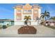 Stunning multi-story home with colorful accents, garages, landscaping and tile roof at 146 175Th Terrace E Dr, Redington Shores, FL 33708