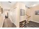 Hallway with wood-look tile flooring leading to stairs and multiple rooms with closet space at 146 175Th Terrace E Dr, Redington Shores, FL 33708