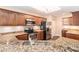 A spacious kitchen featuring stainless steel appliances, granite countertops, and brown cabinets at 146 175Th Terrace E Dr, Redington Shores, FL 33708