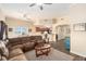 Open floor plan with a Living Room featuring a cozy sofa, television, and ceiling fans at 146 175Th Terrace E Dr, Redington Shores, FL 33708