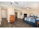 Spacious main bedroom with wood-look tile flooring, ceiling fan, dresser, and an ensuite bathroom at 146 175Th Terrace E Dr, Redington Shores, FL 33708