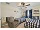 Cozy bedroom with twin beds, ceiling fan, and racing decor, perfect for children or guests at 15721 Starling Water Dr, Lithia, FL 33547