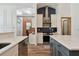 View of the modern kitchen featuring an island, stainless hood and appliances, and ample counter space at 15721 Starling Water Dr, Lithia, FL 33547
