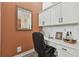 Cozy built-in office nook with desk, cabinets, shelving, mirror, and decor at 15721 Starling Water Dr, Lithia, FL 33547
