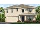 Two story home with a two car garage, neutral color scheme, and a covered porch at 17351 Wheatberry Blvd, Parrish, FL 34219