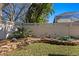 Landscaped backyard featuring a stone wall and lush greenery provides a tranquil and private outdoor space at 18149 Regents Square Dr, Tampa, FL 33647