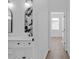 Hallway view of bathroom with updated fixtures and a decorative mirror feature above a single sink vanity at 204 Sandra Ave, Brandon, FL 33510