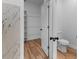 Bathroom featuring a toilet and a view into the walk-in closet with shelves at 204 Sandra Ave, Brandon, FL 33510