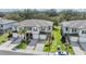 Aerial view of townhomes features well-manicured lawns and individual driveways, creating curb appeal at 21404 Darter Rd, Land O Lakes, FL 34638