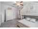 Cozy bedroom features a unique, whitewashed bunk bed and neutral decor, illuminated by a ceiling fan at 21404 Darter Rd, Land O Lakes, FL 34638