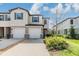 Charming townhome with a two-car garage, stone accents, and well-kept landscaping at 21404 Darter Rd, Land O Lakes, FL 34638
