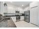 Well-equipped kitchen with stainless steel appliances, granite countertops, and sleek white cabinetry at 21404 Darter Rd, Land O Lakes, FL 34638