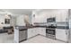 Modern kitchen featuring stainless steel appliances, granite countertops, open concept, and white cabinetry at 21404 Darter Rd, Land O Lakes, FL 34638