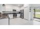 Modern kitchen featuring stainless steel appliances, granite countertops, backyard access, and white cabinetry at 21404 Darter Rd, Land O Lakes, FL 34638