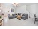 Spacious living room featuring tile floors, a gray sofa, and neutral walls at 21404 Darter Rd, Land O Lakes, FL 34638