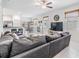 Open-concept living room with tile floors, comfortable seating, and a view of the dining area at 21404 Darter Rd, Land O Lakes, FL 34638