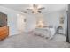 Cozy main bedroom featuring carpeted floors, modern decor, and a ceiling fan at 21404 Darter Rd, Land O Lakes, FL 34638