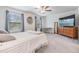 Spacious main bedroom featuring carpeted floors, natural light, modern decor, and a ceiling fan at 21404 Darter Rd, Land O Lakes, FL 34638