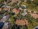 An aerial view of a community featuring multiple townhouses with mature trees and green landscaping at 2180 Clover Hill Rd, Palm Harbor, FL 34683