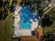 A bird's-eye view of the community pool, complete with seating and set amidst well-maintained landscaping at 2180 Clover Hill Rd, Palm Harbor, FL 34683