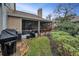 A screened-in porch and an outdoor grill on a grassy backyard at 2180 Clover Hill Rd, Palm Harbor, FL 34683