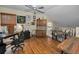 Spacious bonus room with a ceiling fan, desk, and hardwood floors at 2180 Clover Hill Rd, Palm Harbor, FL 34683