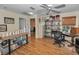 Upstairs bonus room with bamboo flooring, bookcases, and a view of the landing at 2180 Clover Hill Rd, Palm Harbor, FL 34683