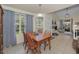 Cozy dining room showcasing neutral walls, natural light, tile floors, and seamless flow to the living spaces at 2180 Clover Hill Rd, Palm Harbor, FL 34683