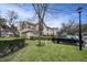 A charming two-story townhouse with lush landscaping, a green lawn, and a black pickup truck parked nearby at 2180 Clover Hill Rd, Palm Harbor, FL 34683