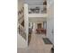 Inviting foyer featuring staircase, tile flooring, dining area and an upper level balcony overlooking the front entrance at 2180 Clover Hill Rd, Palm Harbor, FL 34683